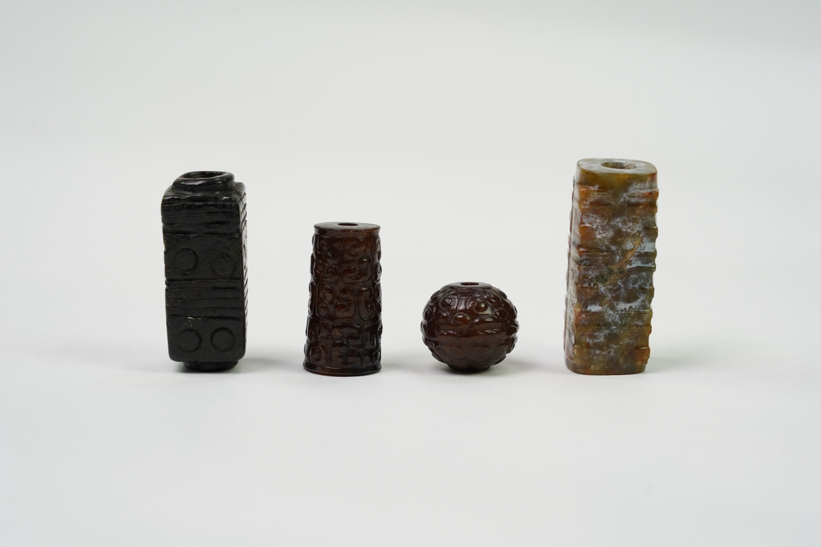A group of four Chinese archaistic jade beads
